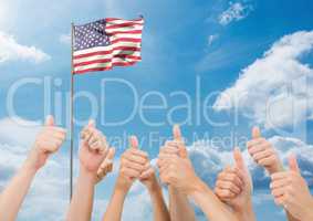 American flag flapping in sky and hands showing thumbs up sign