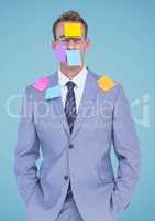 Businessman standing with sticky notes on his face