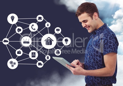 Happy man using digital tablet with connecting icons in background