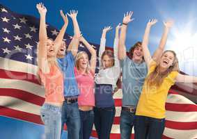 Group of young people cheering against American flag