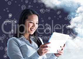 Happy woman holding digital tablet and connecting icons with cloud in background