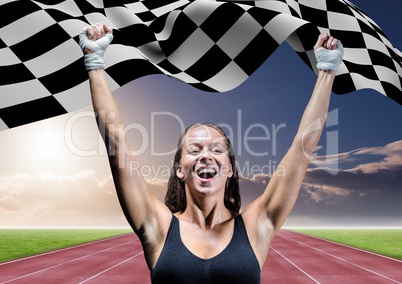 Athlete celebrating her victory with checkered flag on race track