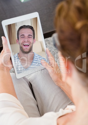 Senior woman having a video call with her son in digital tablet