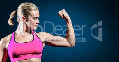 Woman flexing her arms against blue background