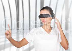Woman in virtual reality glasses using digital screen