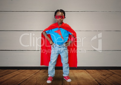 Digital composite image of boy pretending to be a superhero