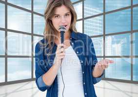 Female executive speaking over microphone in office