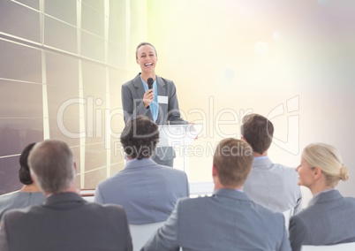 Businessman speaking in microphone at meeting