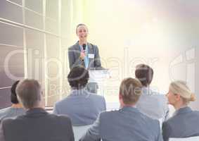 Businessman speaking in microphone at meeting
