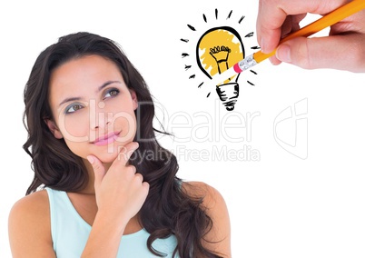 Thoughtful woman looking at drawn innovation bulb against white background