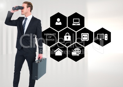 Businessman with briefcase looking through binoculars standing against various applications