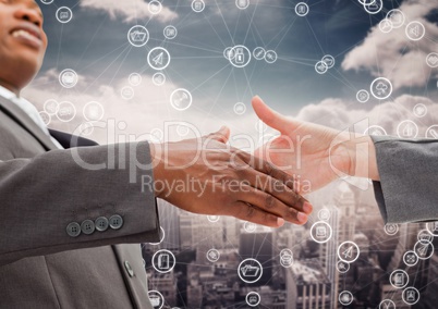 Business professionals shaking hands with handcuff against digital interface in background