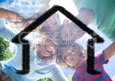 Family hugging each other against house outline in background