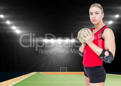 Female handball player holding ball at handball court