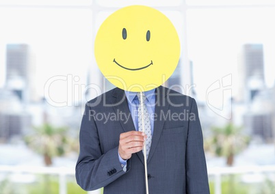 Businessman holding a smiley