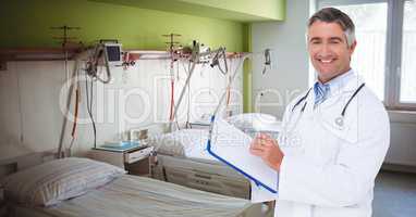 Portrait of smiling doctor holding clipboard in hospital