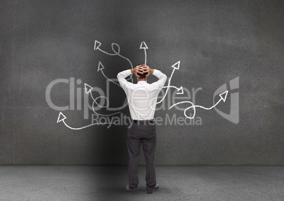 Frustrated business professional looking at the blackboard