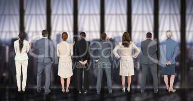 Business people standing in a row against digitally generated background