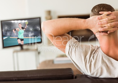 Man watching handball on television at home