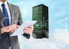 Businessman using digital tablet against background with server building in sky