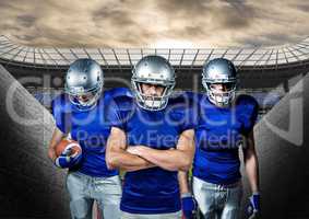 American football players standing against stadium in background