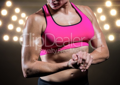 Strong woman posing against black illuminated background