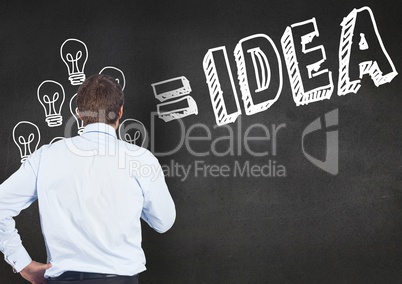 Thoughtful businessman looking at bulbs and idea text on blackboard