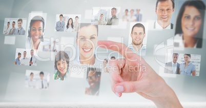 Finger touching profile picture of business people