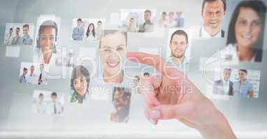 Finger touching profile picture of business people