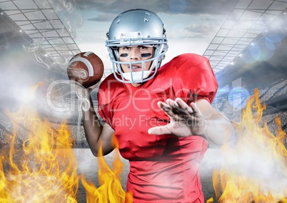 Portrait of athlete playing american football between the fire flame