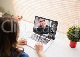 Woman having a video call with her friend on laptop