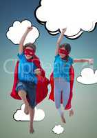 Two children wearing superhero costume enjoying against sky background