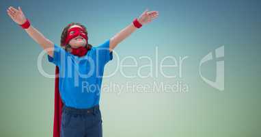 Smiling boy wearing superhero costume standing with arms outstretched