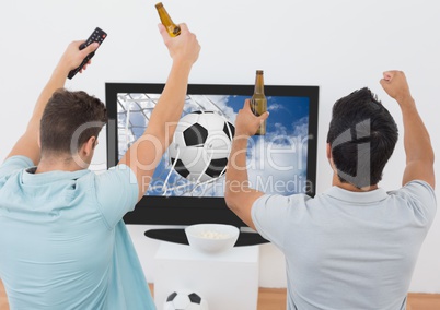 Two excited men cheering with beer bottle while watching sport match on tv