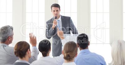 Businessman giving a speech in conference hall