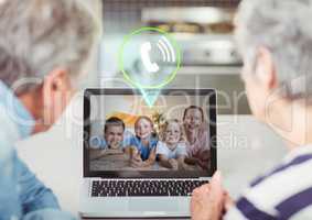 Senior couple having video call with family on laptop