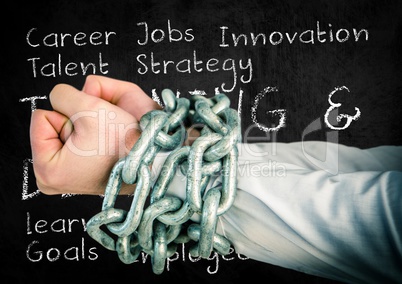 Businessman hands bound in chains