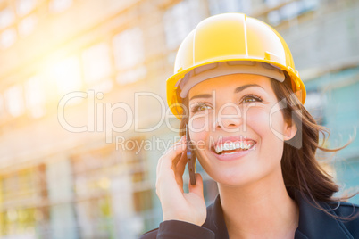 Young Female Contractor Wearing Hard Hat on Site Using Phone