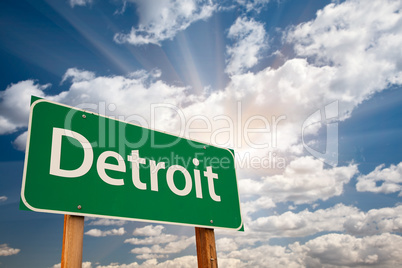 Detroit Green Road Sign Over Clouds