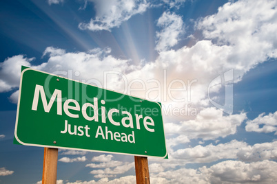 Medicare Green Road Sign Over Clouds