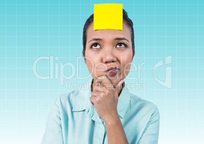Thoughtful businesswoman with blank yellow sticky note on forehead