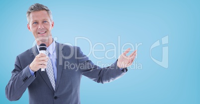 Businessman speaking with microphone against blue background