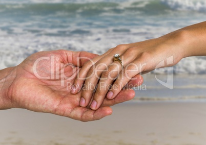 Newly wed couple holding hands on beach