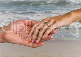 Newly wed couple holding hands on beach