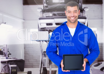 Mechanic holding digital tablet in garage