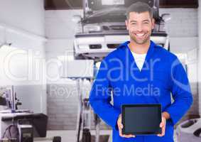 Mechanic holding digital tablet in garage