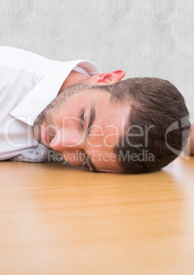 Man laying his head in the desk