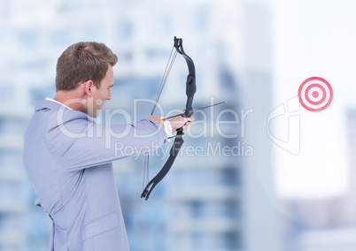 Businessman aiming bow and arrow at target