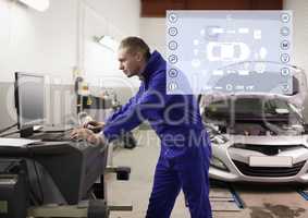 Mechanic using desktop pc at garage