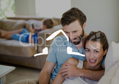 Romantic couple sitting in living room with house outline